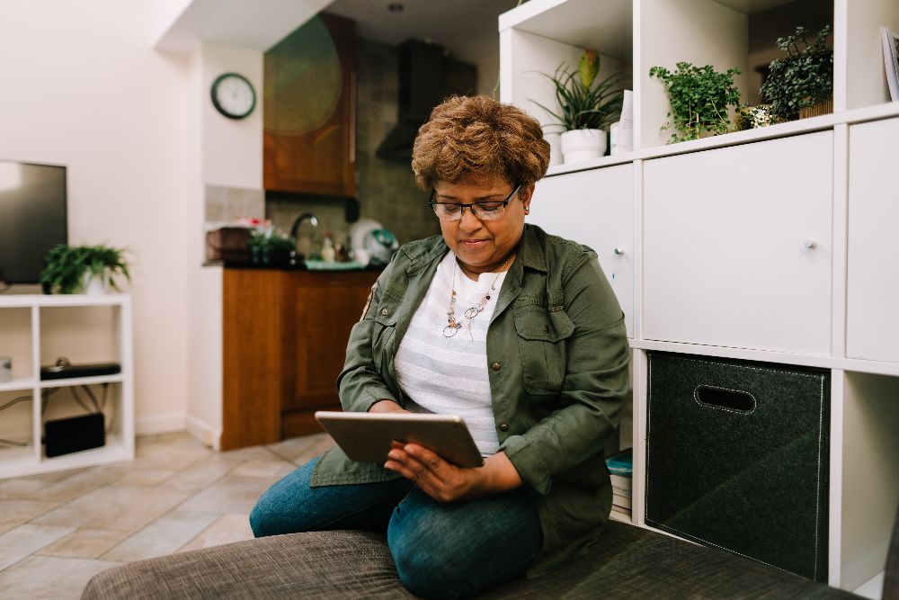 Woman using tablet while sitting at home