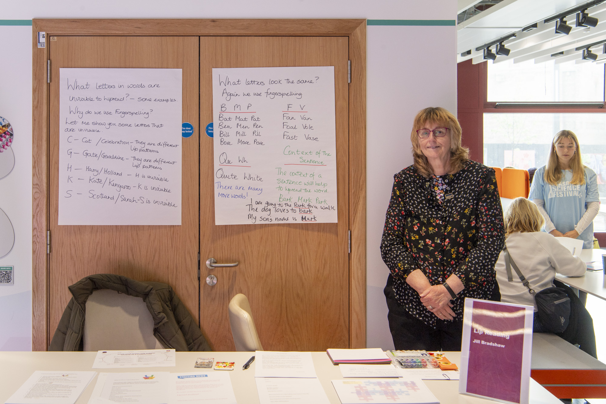 Instructor pointing to education materials displayed on doors during workshop