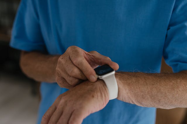 A Person Wearing White and Black Smart Watch